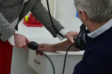 man getting blood pressure taken manually