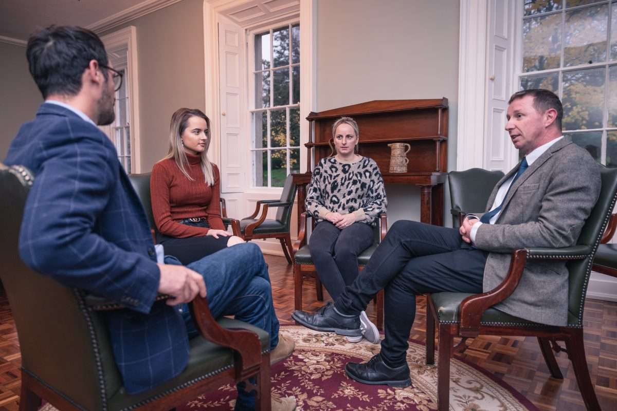 Two men and two women sat on chairs talking discussing cocaine detox at smarmore castle