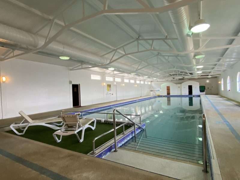 Our facility: Indoor swimming pool with two lounge chairs