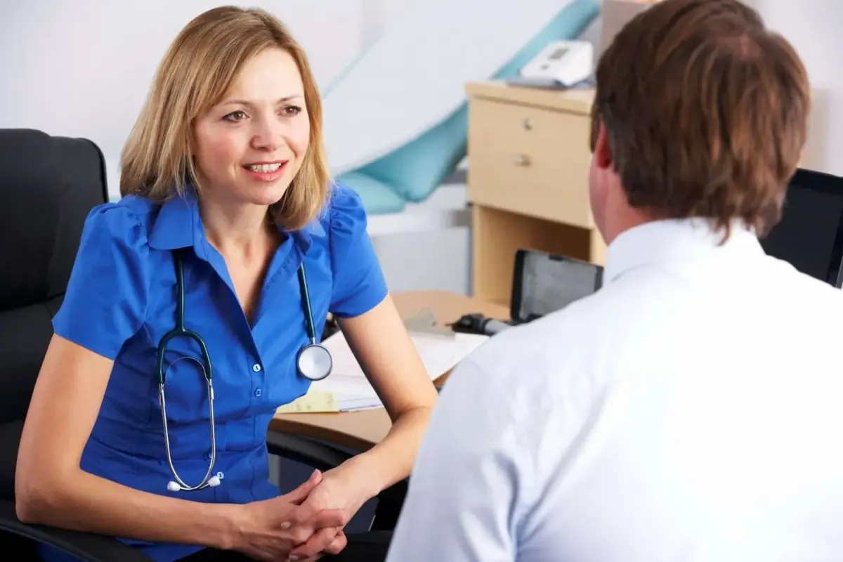 A Dr talking to a patient with a stethoscope around her neck