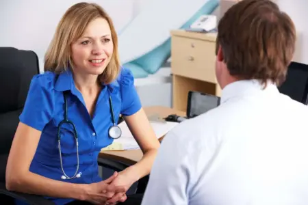 A Dr talking to a patient with a stethoscope around her neck