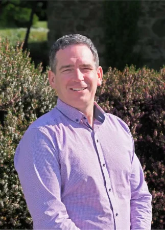 Portrait photo of Stephen Murray, addiction therapist at Smarmore Castle, photo taken outside against greenery