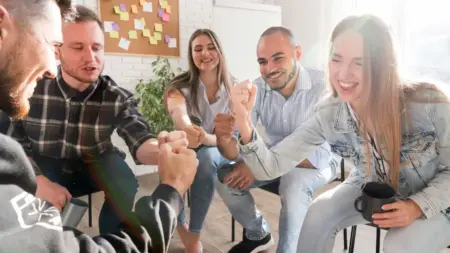 A group of people playing rock paper scissors