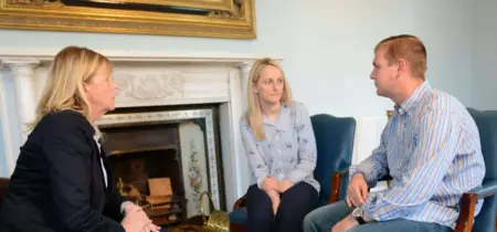 Three people talking in a group therapy session for addiction at Smarmore Castle rehab clinic
