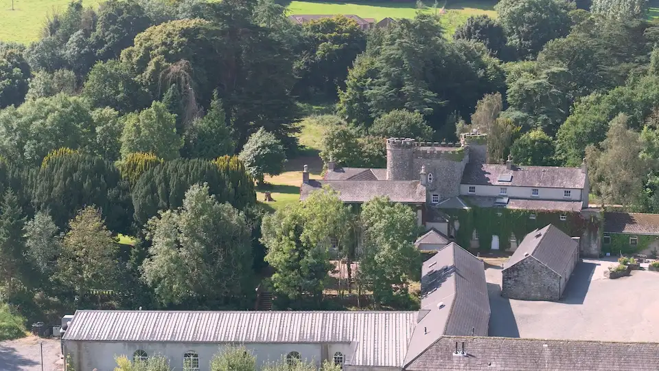 Aerial shot of Smarmore Castle and the surrounding grounds and trees