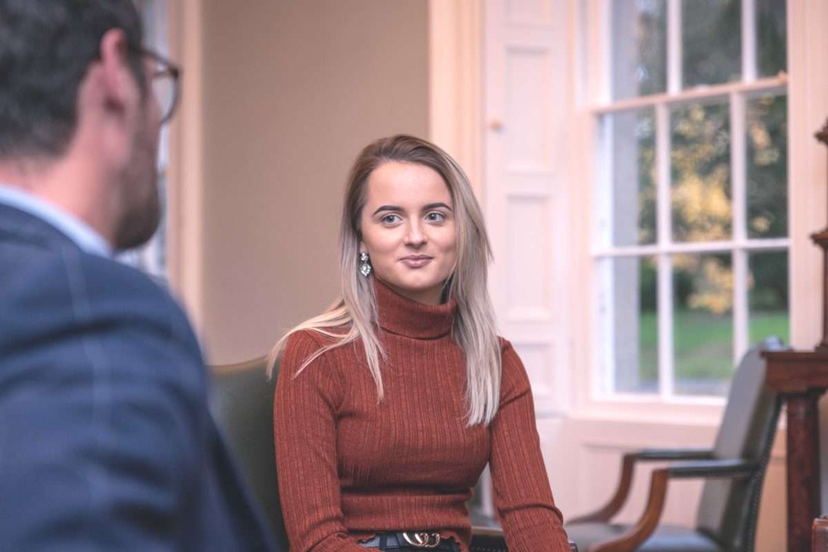 A woman talking to her therapist indoors at Smarmore Castle about treatment for cannabis addiction.