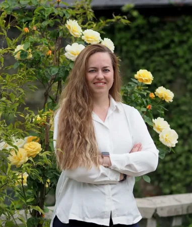 Portrait photo of Nicki Annunziata, deputy lead nurse at Smarmore Castle, photo taken outside with yellow flowers in the background