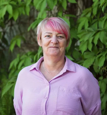Portrait photo of Val Ward, recovery advocate at Smarmore Castle, photo taken outside against greenery