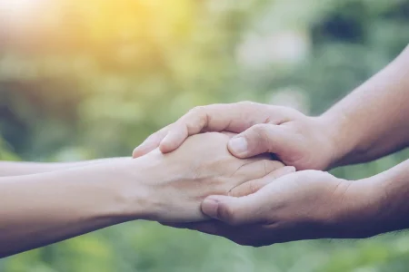 Close up image of hand holding with blurred natural background